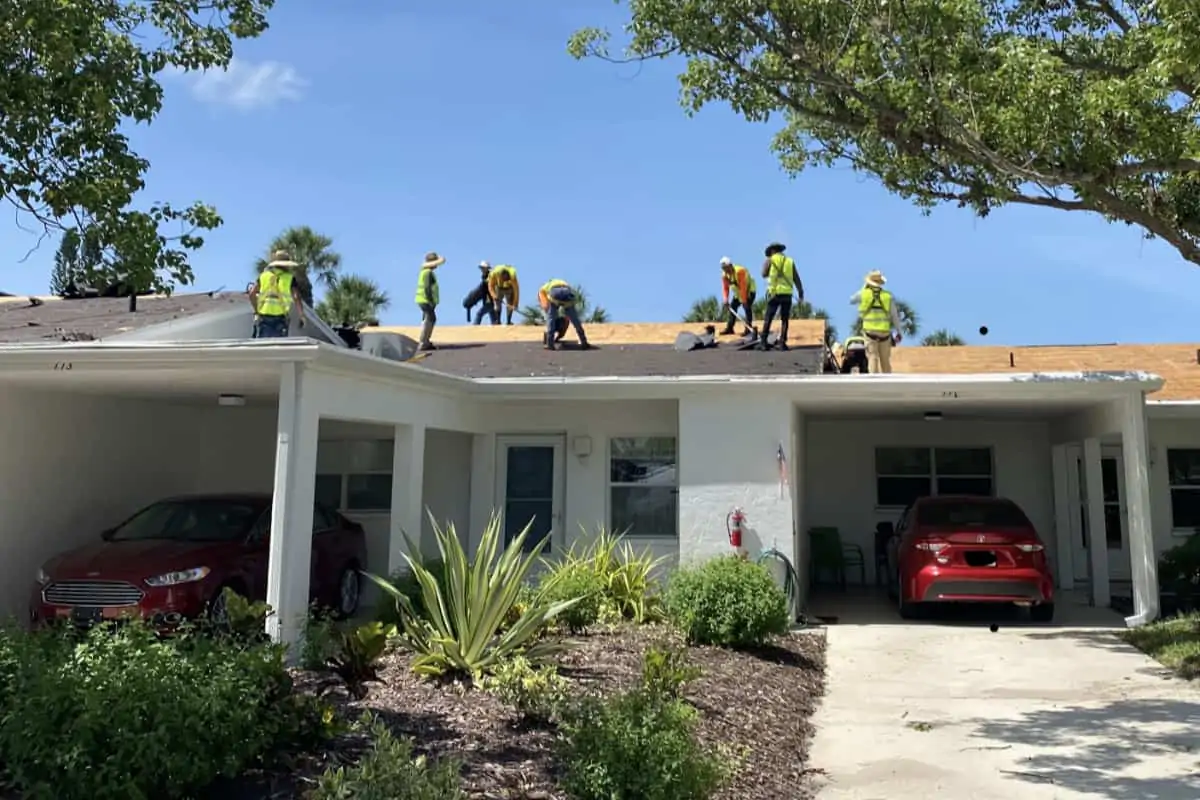 Roofers replacing a residential roof.